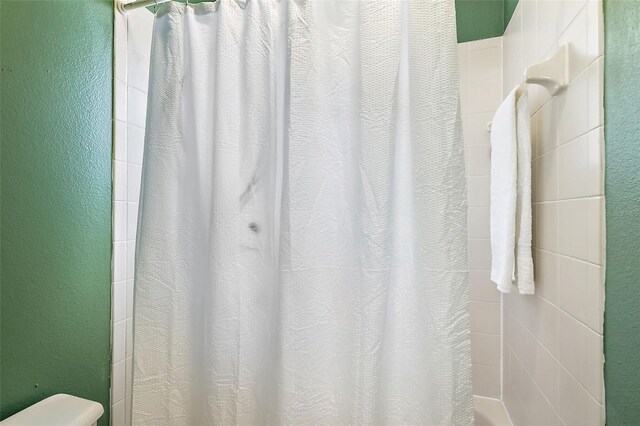 14701 Timucua Pl, Clermont, FL 34711 - full bathroom with a shower with shower curtain and toilet
