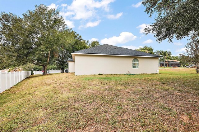 view of side of property featuring a yard