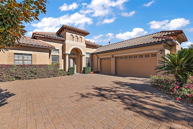 mediterranean / spanish-style house with a garage