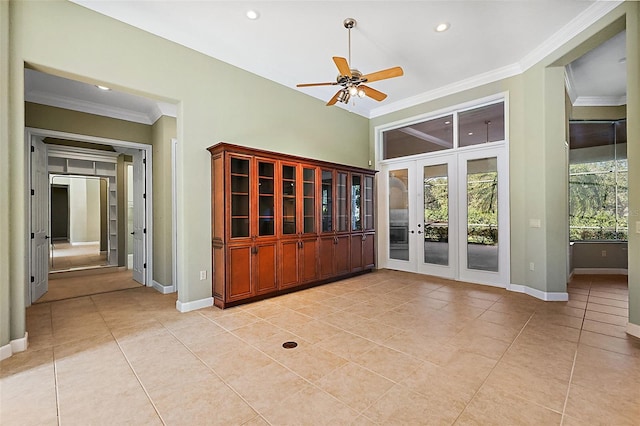 tiled empty room with ceiling fan, ornamental molding, and french doors