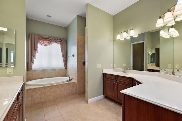 bathroom featuring tile patterned flooring, vanity, and tiled tub