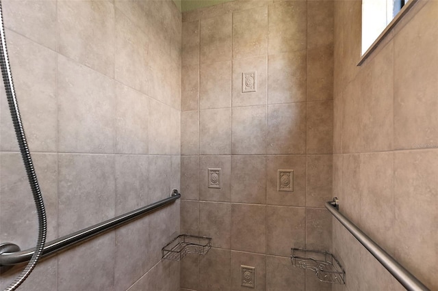 interior details featuring tiled shower