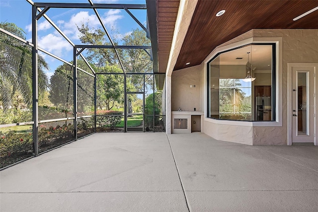 view of patio with glass enclosure