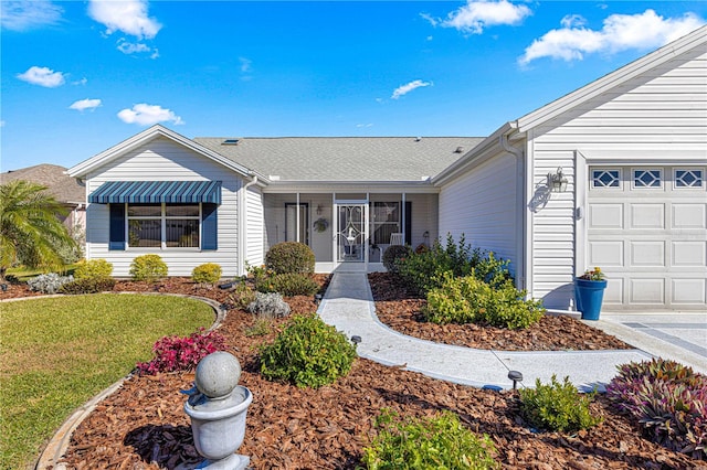 ranch-style home featuring a garage and a front lawn