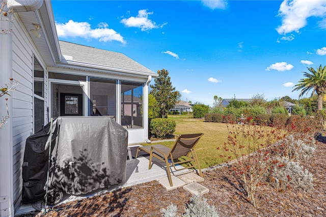 view of yard featuring a sunroom and a patio