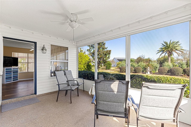 sunroom / solarium featuring ceiling fan