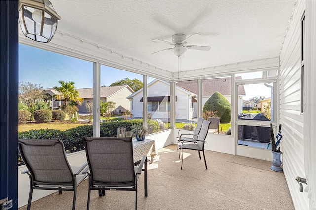 sunroom featuring ceiling fan and plenty of natural light