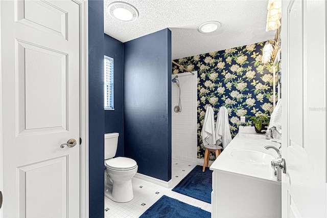 bathroom with vanity, a textured ceiling, toilet, and walk in shower