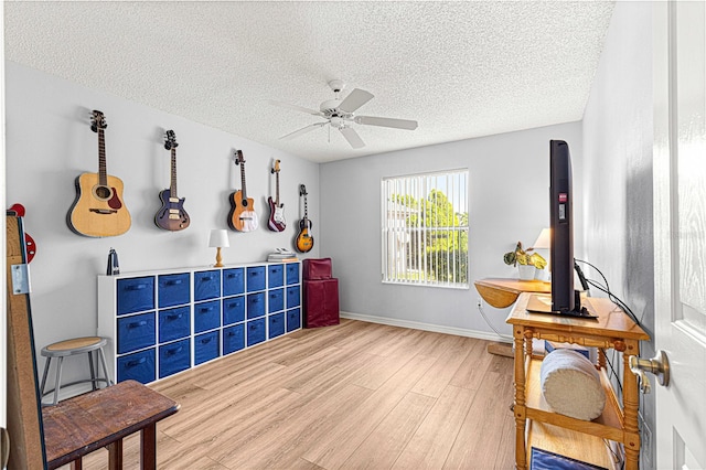 interior space featuring hardwood / wood-style floors, ceiling fan, and a textured ceiling