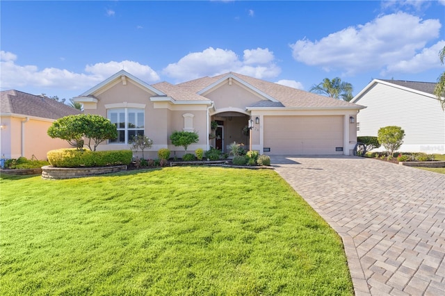 ranch-style house with a garage and a front yard