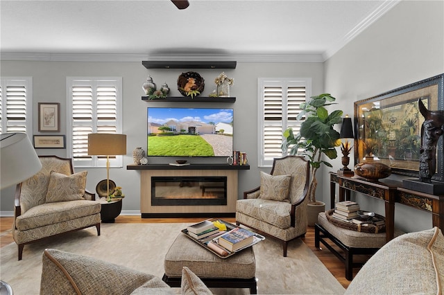 living room featuring plenty of natural light, ornamental molding, and light hardwood / wood-style flooring