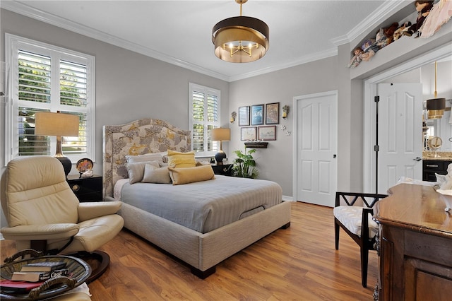 bedroom featuring multiple windows, crown molding, and light hardwood / wood-style flooring