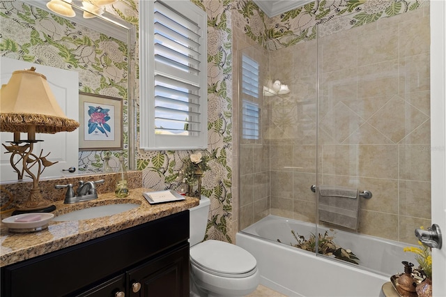 full bathroom with vanity, tiled shower / bath combo, toilet, and crown molding