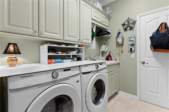 clothes washing area with washer and clothes dryer, cabinets, light tile patterned floors, and crown molding