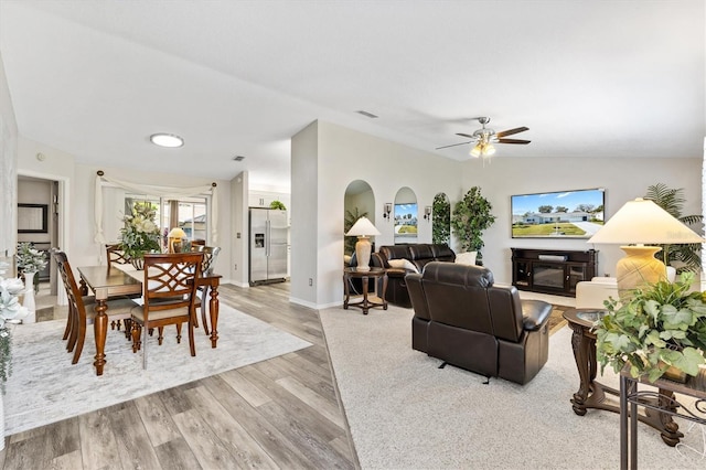 living room featuring light hardwood / wood-style floors, ceiling fan, and lofted ceiling