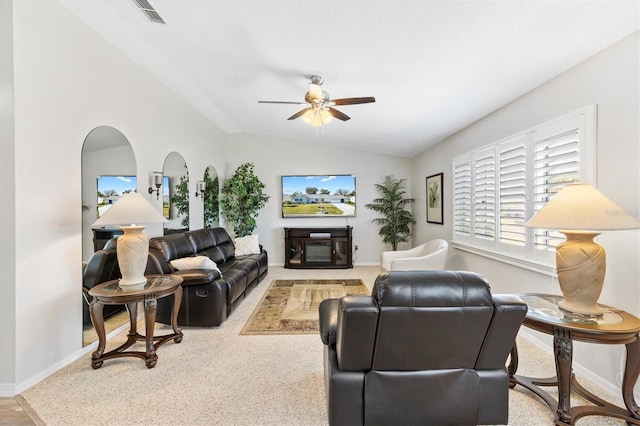 carpeted living room featuring ceiling fan and vaulted ceiling