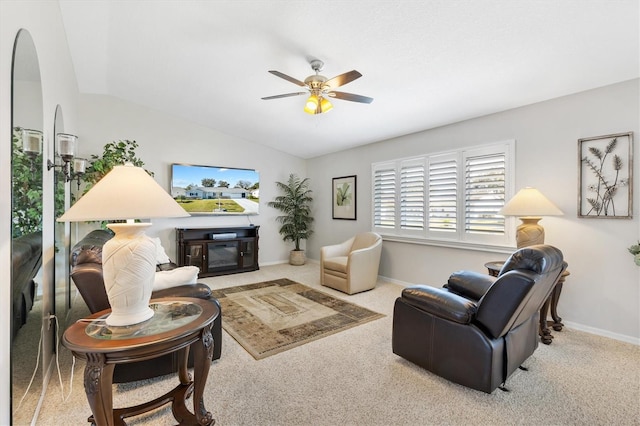 living room featuring ceiling fan, light colored carpet, and vaulted ceiling