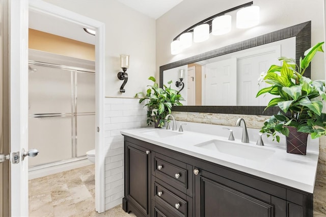 bathroom with vanity, toilet, and an enclosed shower