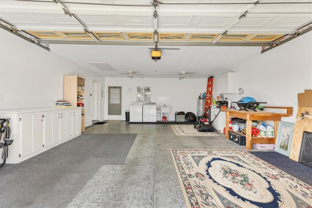 garage with washer and dryer, ceiling fan, and gas water heater