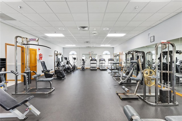 gym with a paneled ceiling