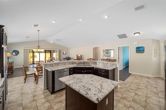 kitchen with a large island with sink, light stone countertops, dishwasher, and lofted ceiling