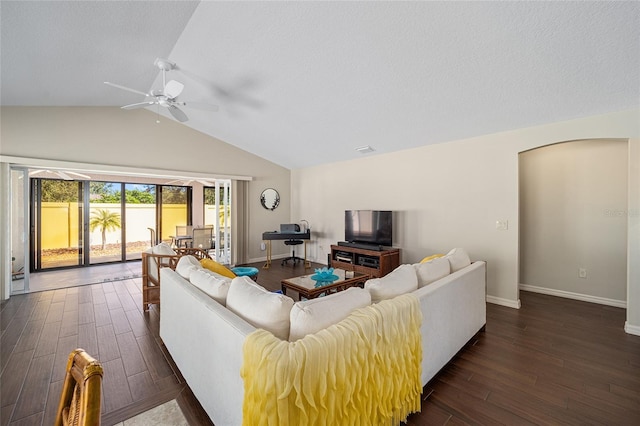 living room with dark wood-type flooring, ceiling fan, and lofted ceiling