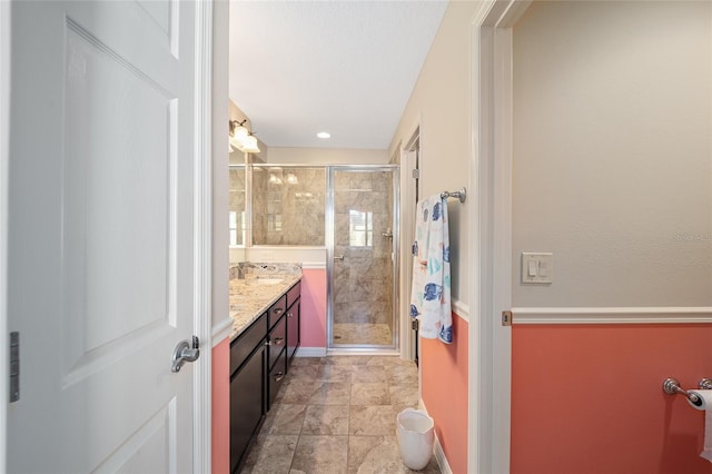 bathroom featuring vanity and an enclosed shower