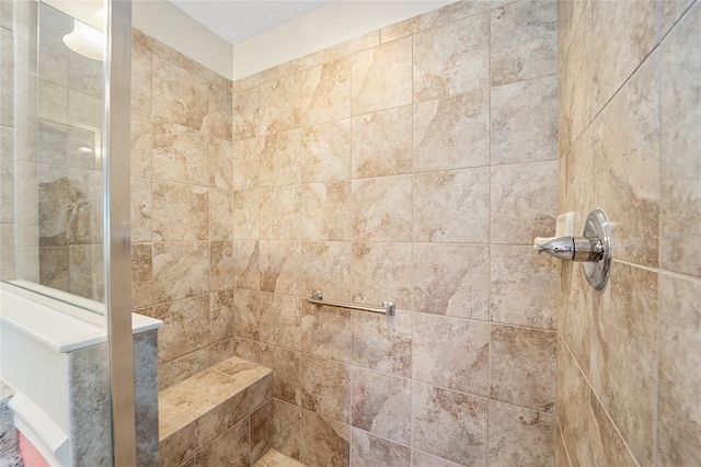 bathroom with tiled shower