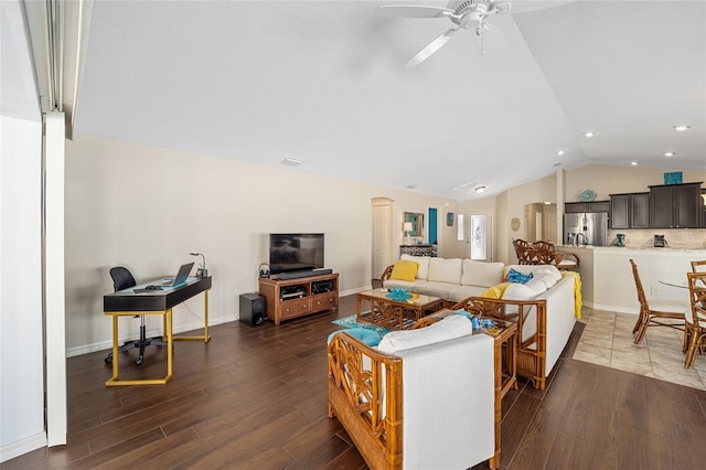 living room featuring ceiling fan, lofted ceiling, and dark wood-type flooring