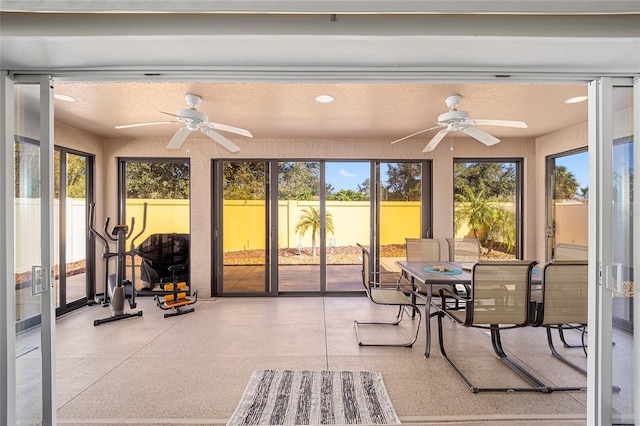 sunroom featuring ceiling fan