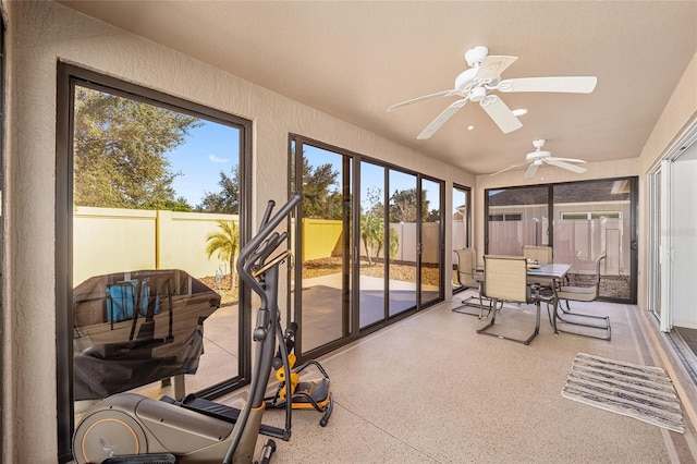 sunroom featuring ceiling fan