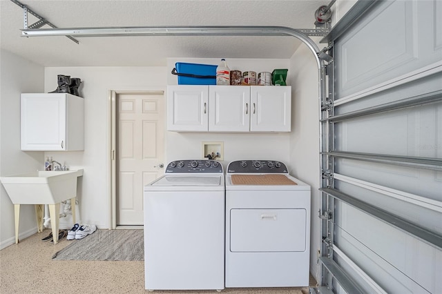 laundry area featuring cabinets and washing machine and clothes dryer