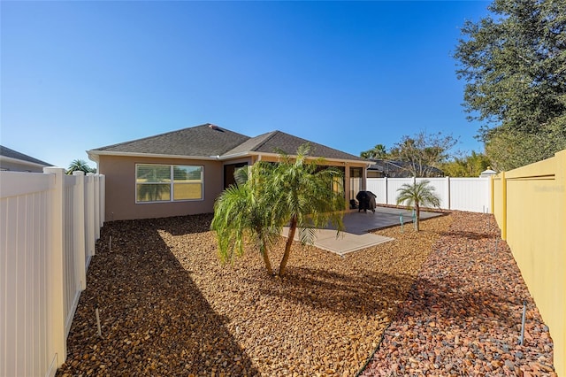 back of property with a patio