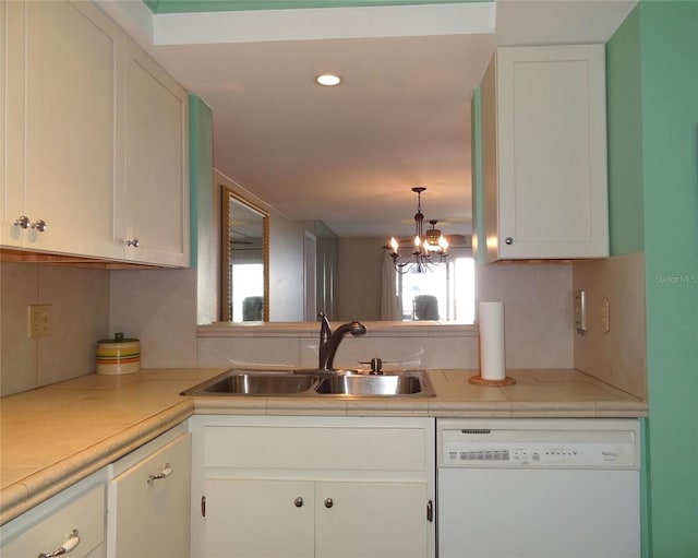 kitchen with dishwasher, white cabinets, and sink