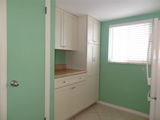 kitchen with white cabinetry and light tile patterned floors