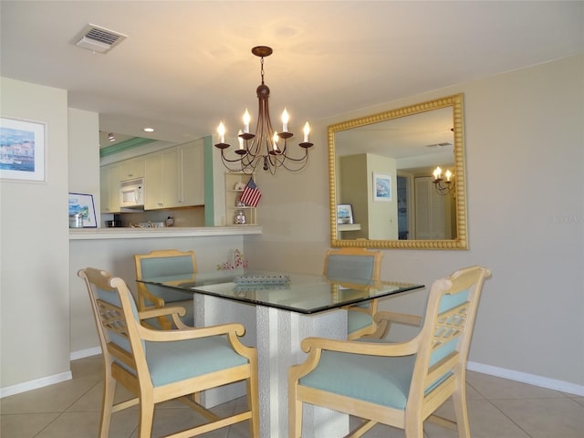 dining room featuring a notable chandelier and light tile patterned flooring