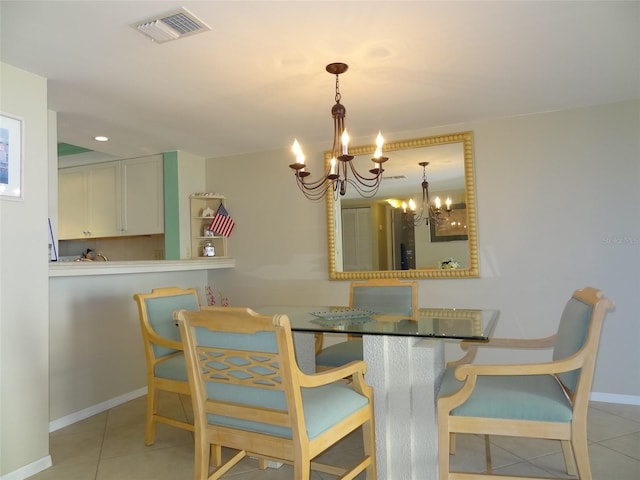 dining room with light tile patterned floors and a notable chandelier