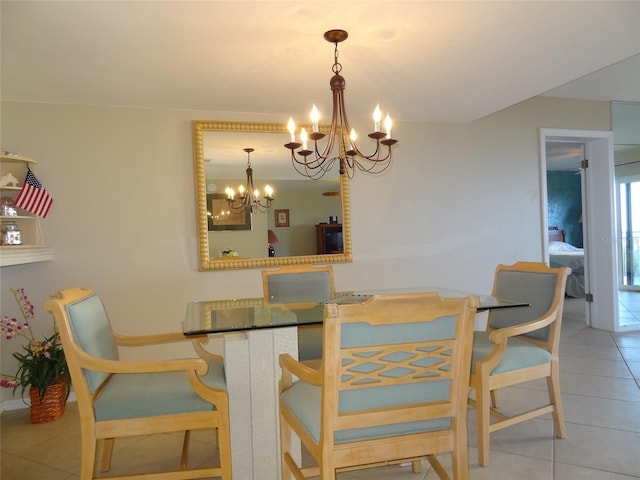 dining area featuring light tile patterned flooring and a chandelier