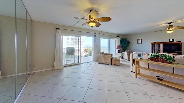 sitting room with light tile patterned floors and ceiling fan