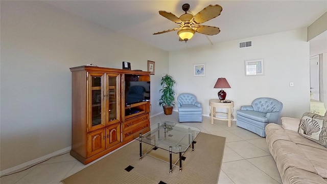 tiled living room with ceiling fan