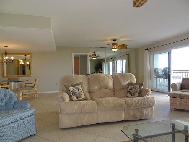 living room featuring light tile patterned floors and ceiling fan with notable chandelier