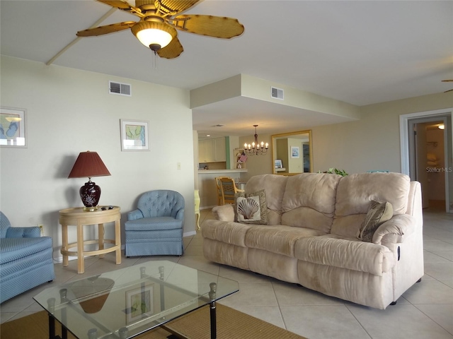 living room with ceiling fan with notable chandelier and light tile patterned floors