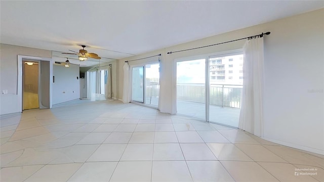 spare room featuring ceiling fan and light tile patterned flooring