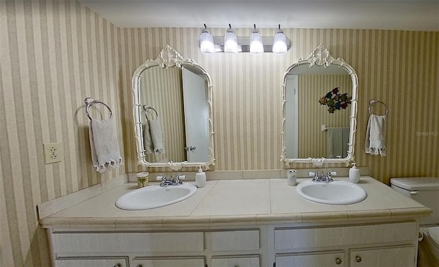 bathroom featuring vanity and toilet