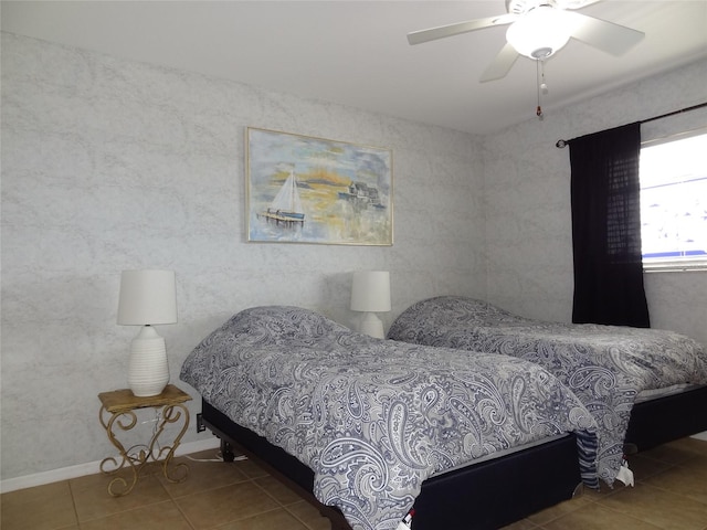 bedroom with ceiling fan and tile patterned flooring