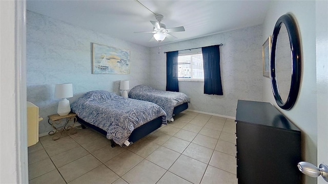 tiled bedroom featuring ceiling fan