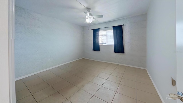 tiled spare room with ceiling fan