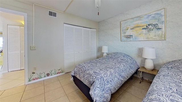 bedroom with a closet and light tile patterned floors