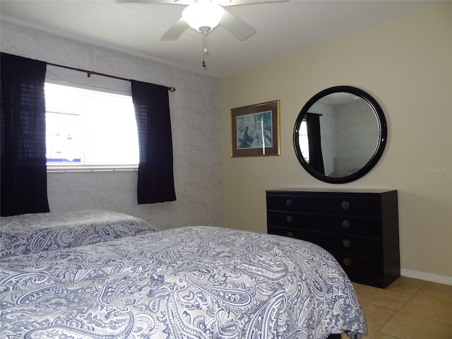 bedroom with ceiling fan and light tile patterned floors