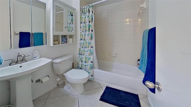 bathroom with tile patterned floors, toilet, and shower / bath combo with shower curtain